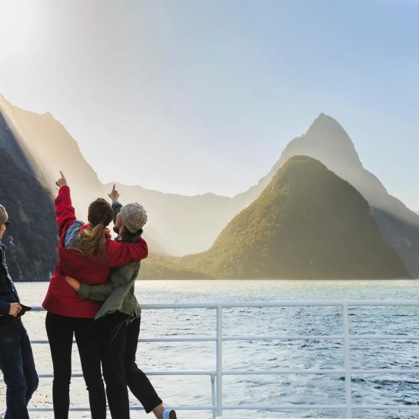 Friends on a boat looking at Milford Sound in New Zealand